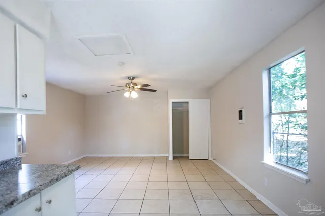a kitchen with granite countertop white cabinets and white appliances
