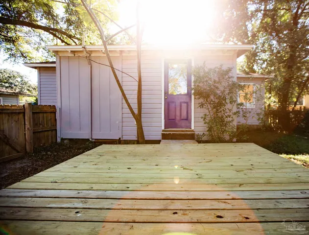 a view of wooden fence and front of house