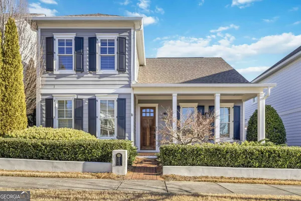 front view of a brick house with a yard