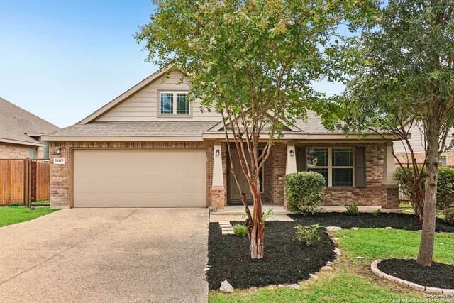 a front view of house with yard garage and green space