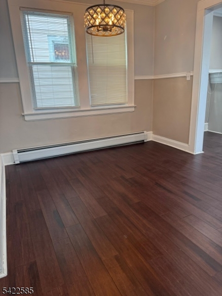 14 Commonwealth Avenue Newark, NJ 07106 - Photo 4 of 5 an empty room with wooden floor cabinet and windows