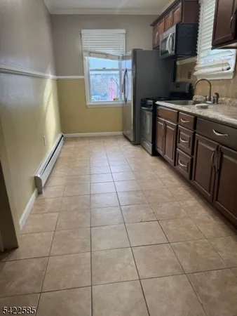 a kitchen with granite countertop a stove a sink and a refrigerator