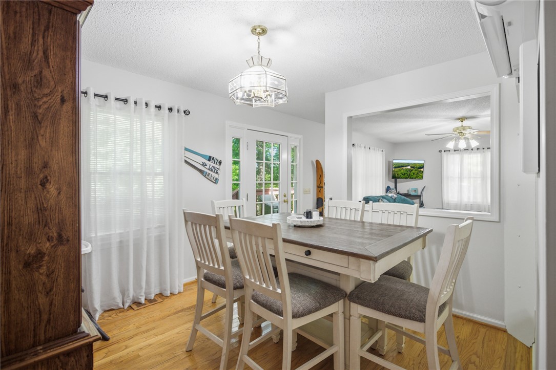 110 Snug Harbor Road Seneca, SC 29678 - Photo 12 of 37 This bright and inviting dining area features warm wood flooring and French doors leading to outdoor space.