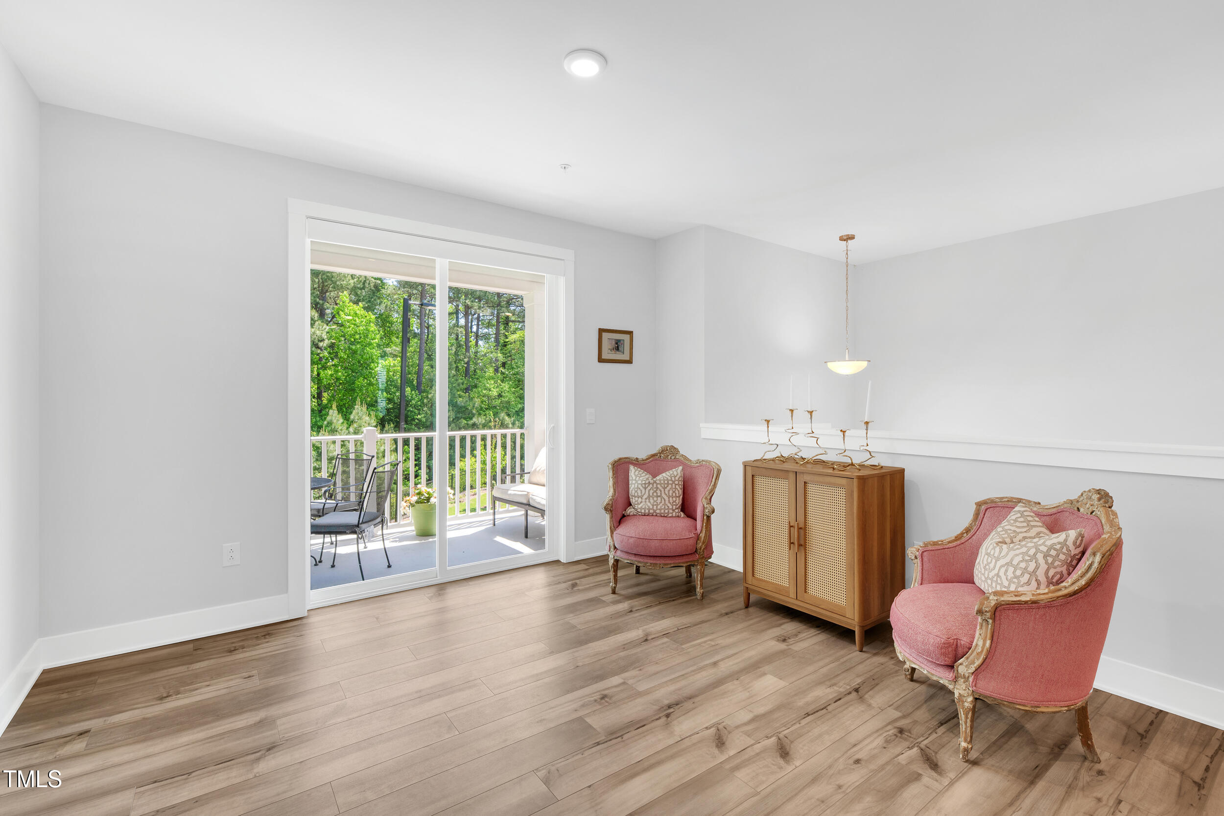 11549 Helmond Way, Unit 107 Raleigh, NC 27617 - Photo 6 of 33 a bedroom with furniture and wooden floor