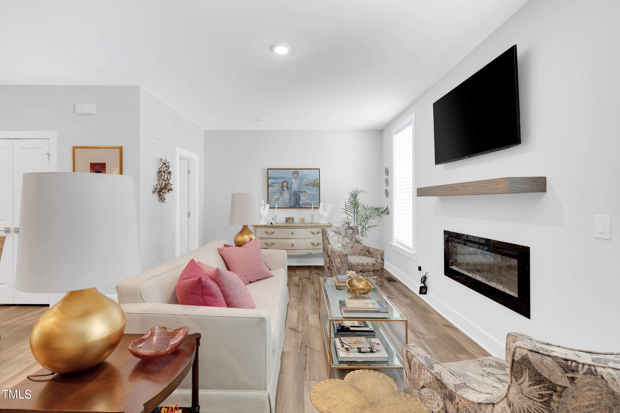 11549 Helmond Way, Unit 107 Raleigh, NC 27617 - Photo 9 of 33 a living room with furniture and a flat screen tv