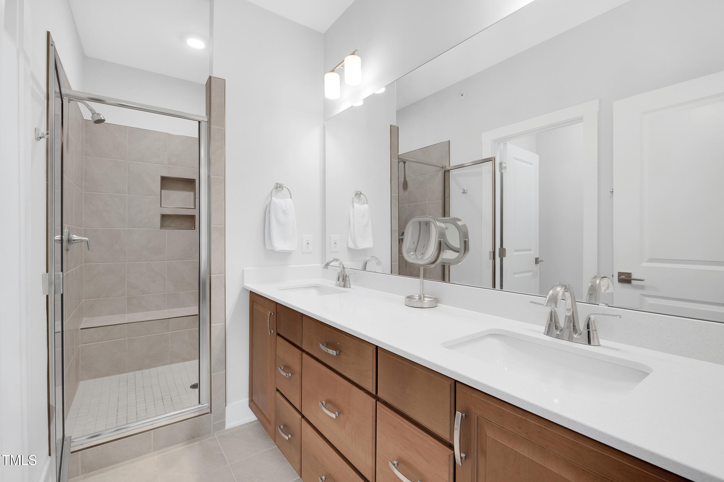 11549 Helmond Way, Unit 107 Raleigh, NC 27617 - Photo 15 of 33 a bathroom with a double vanity sink mirror and double