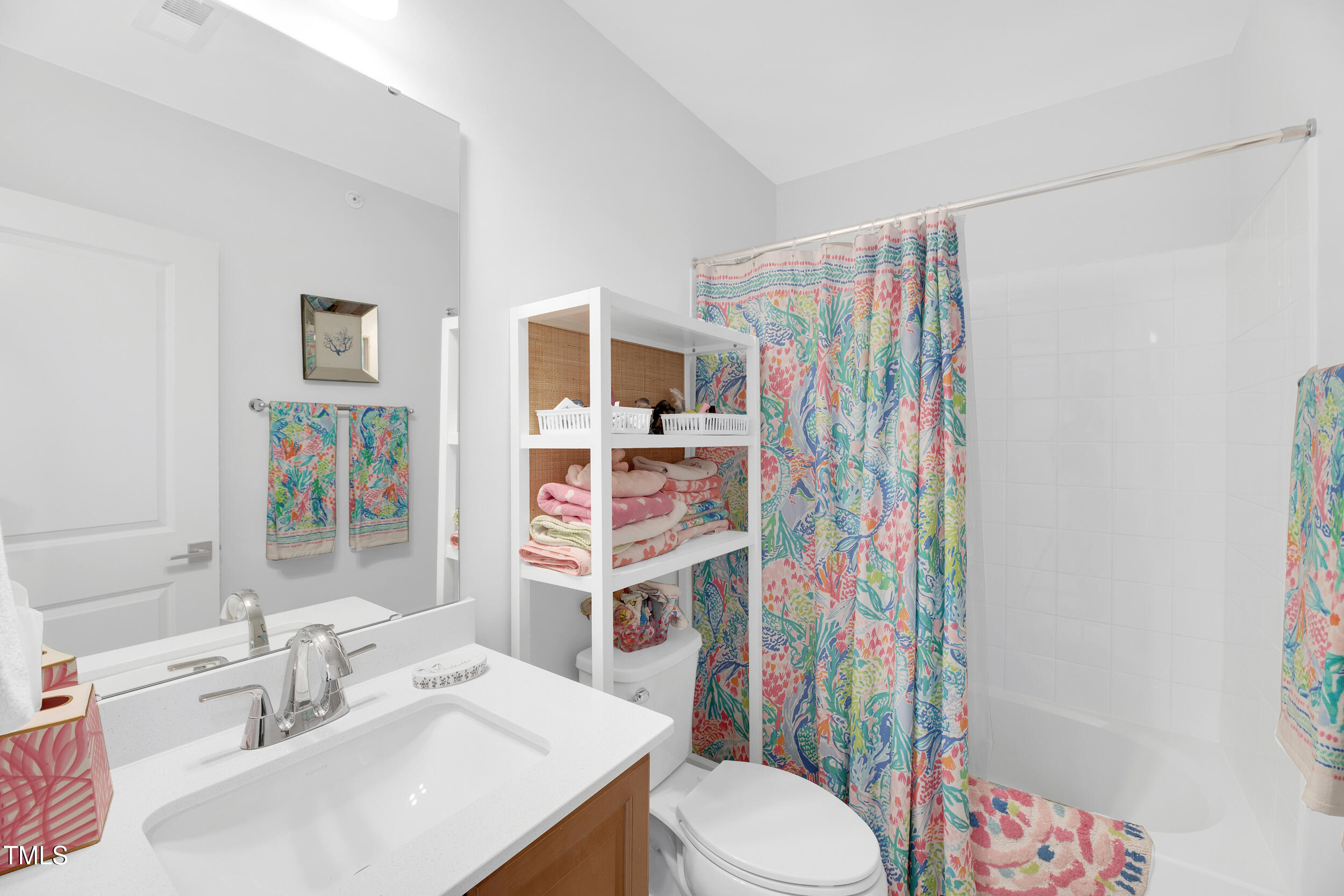 11549 Helmond Way, Unit 107 Raleigh, NC 27617 - Photo 16 of 33 a bathroom with a sink toilet and shower curtain