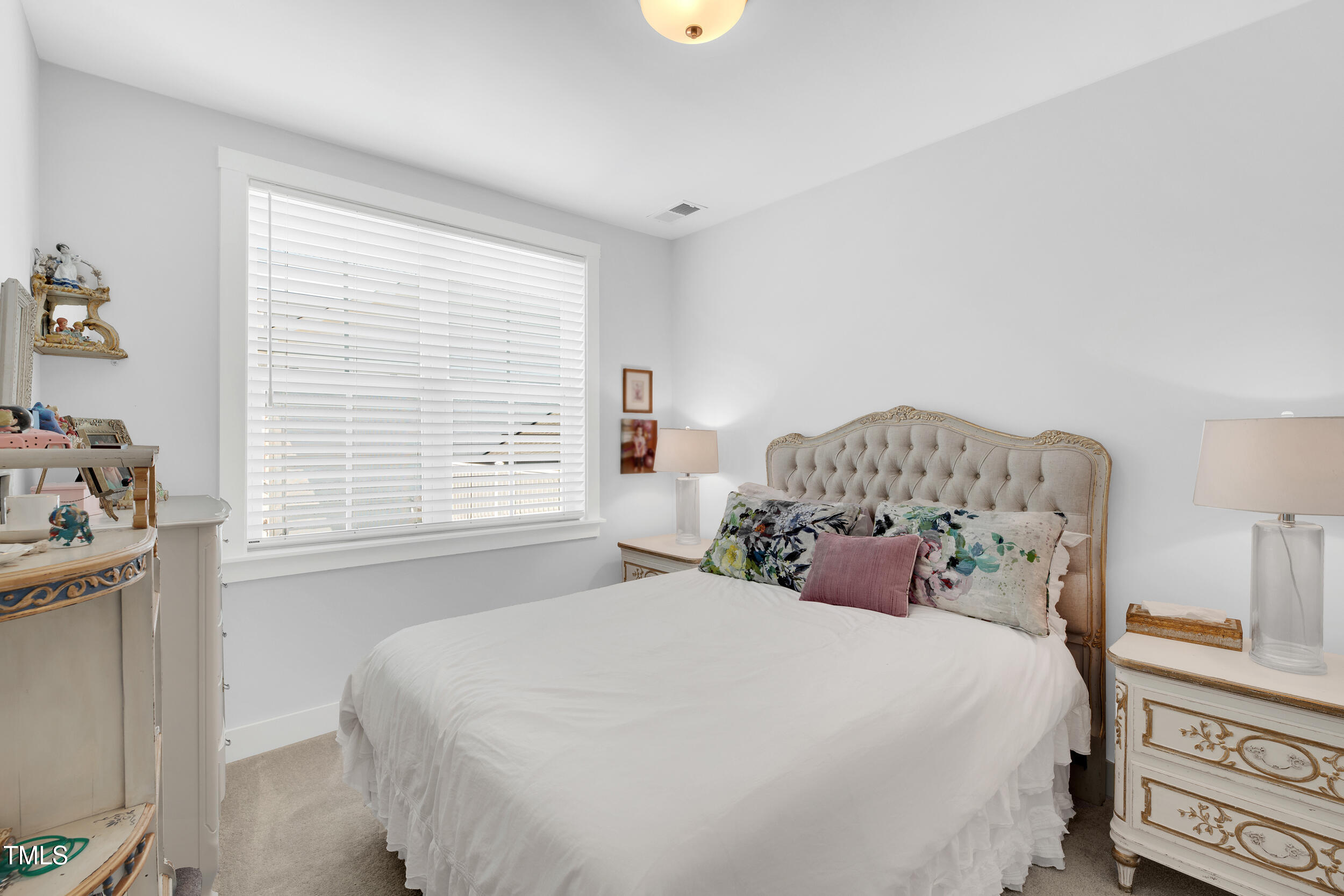 11549 Helmond Way, Unit 107 Raleigh, NC 27617 - Photo 18 of 33 a bedroom with a bed and a window