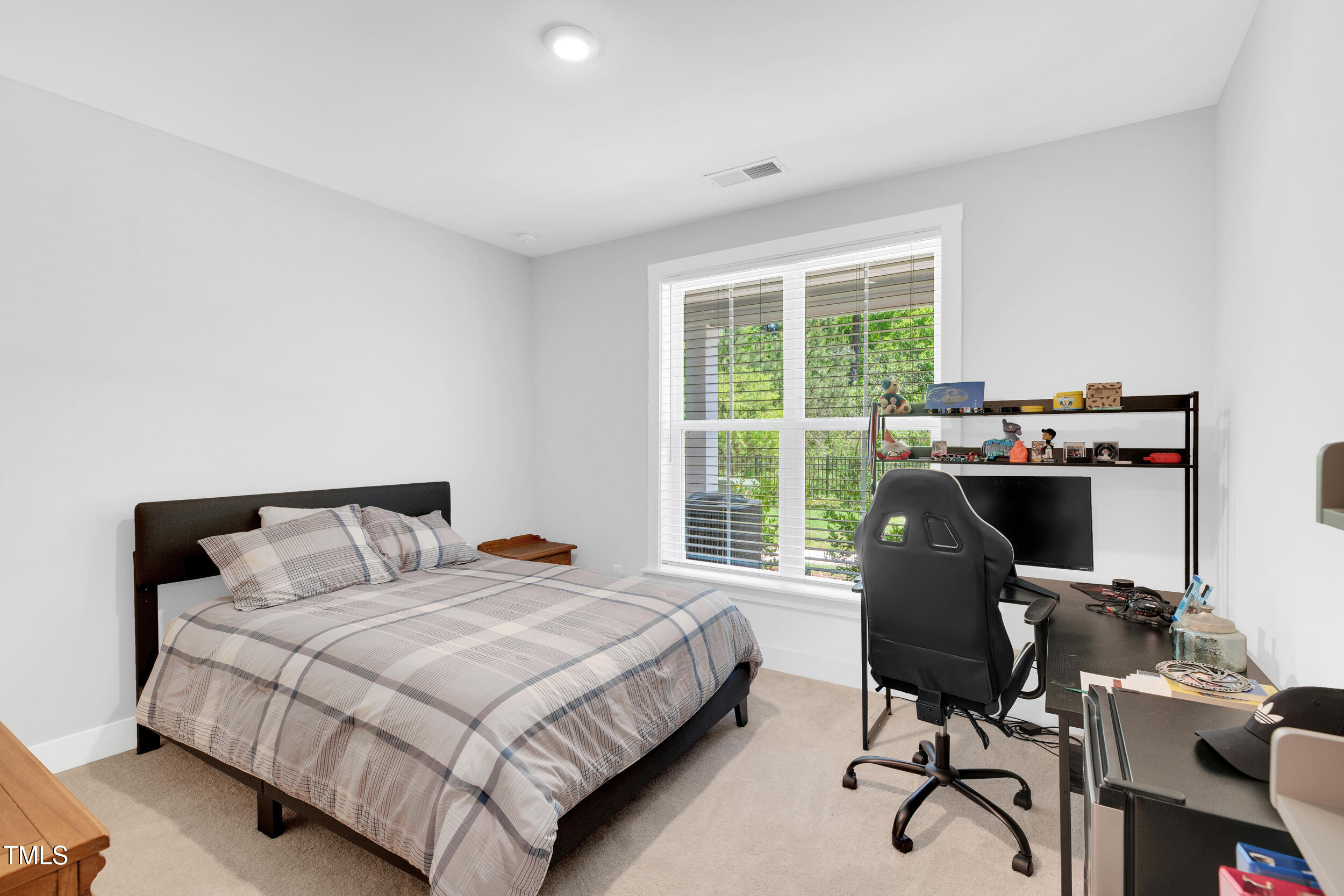 11549 Helmond Way, Unit 107 Raleigh, NC 27617 - Photo 20 of 33 a bedroom with a bed and a desk