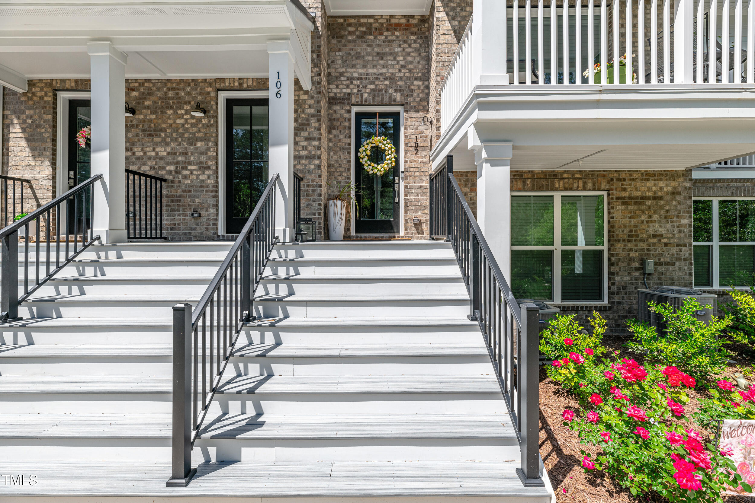 11549 Helmond Way, Unit 107 Raleigh, NC 27617 - Photo 2 of 33 a view of a house with large windows and flower plants