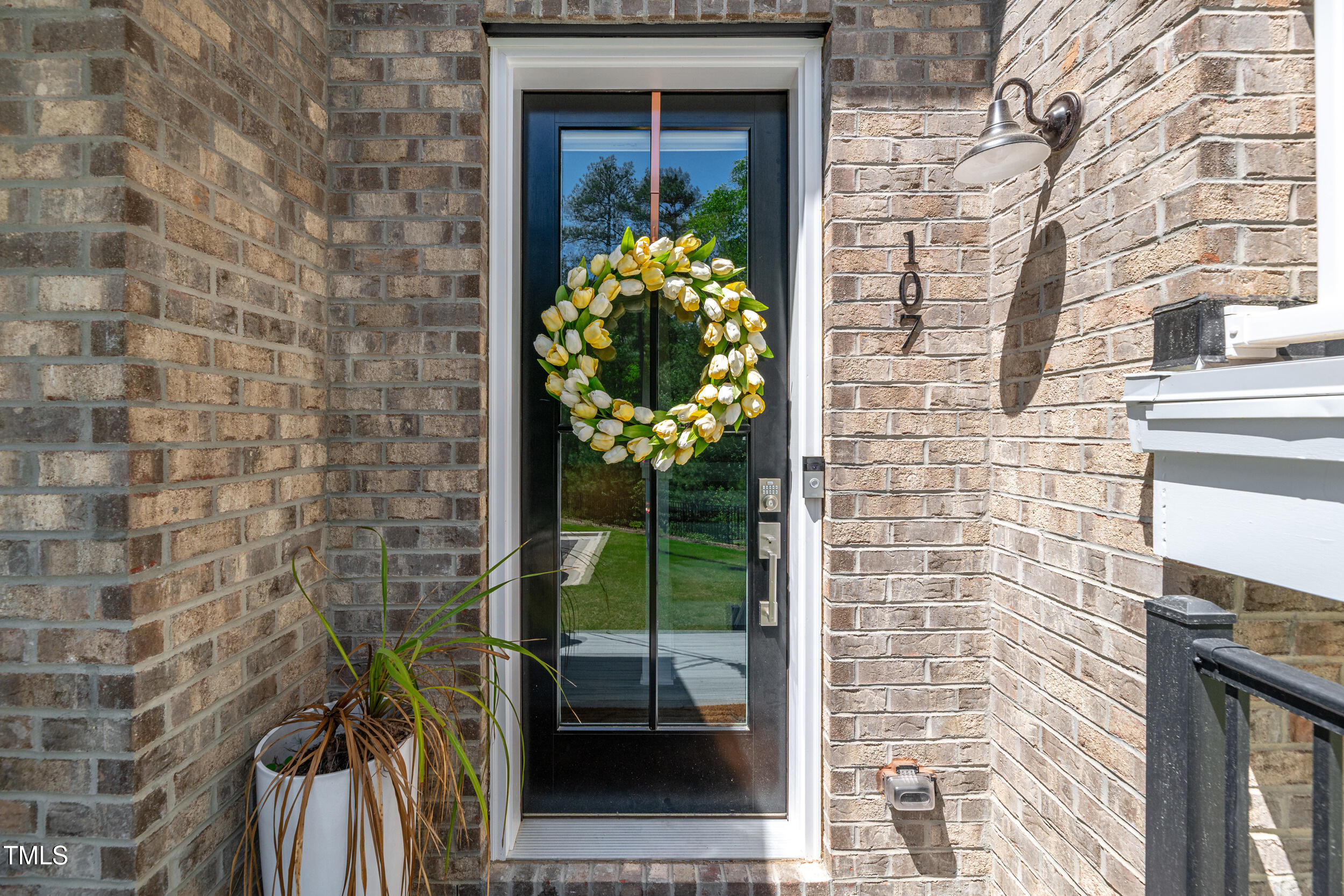 11549 Helmond Way, Unit 107 Raleigh, NC 27617 - Photo 4 of 33 a front view of a house with a garden