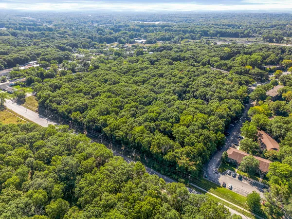an aerial view of residential house with green space