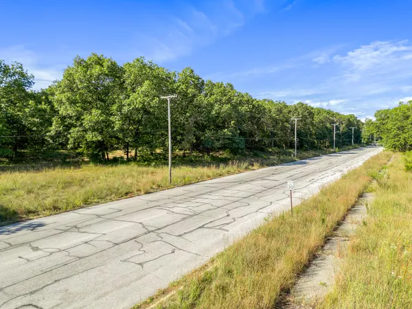 an aerial view of residential houses with city and green space