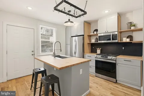 a kitchen with a stove a sink and a refrigerator