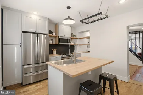 a kitchen with kitchen island a counter space and appliances