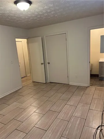 a view of a room with an empty space and a window