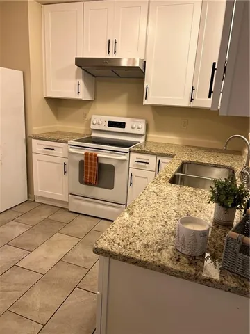 a kitchen with a stove and a cabinets