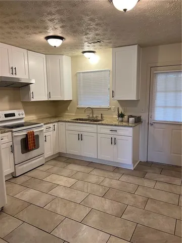 a open kitchen with stainless steel appliances granite countertop a sink and cabinets