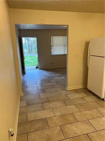 a view of a hallway to a house with windows