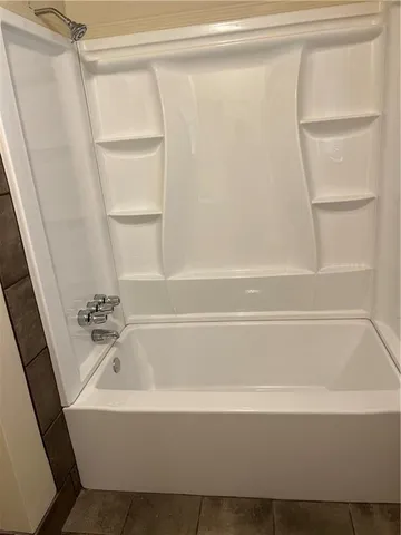 a bathroom with bathtub and shower