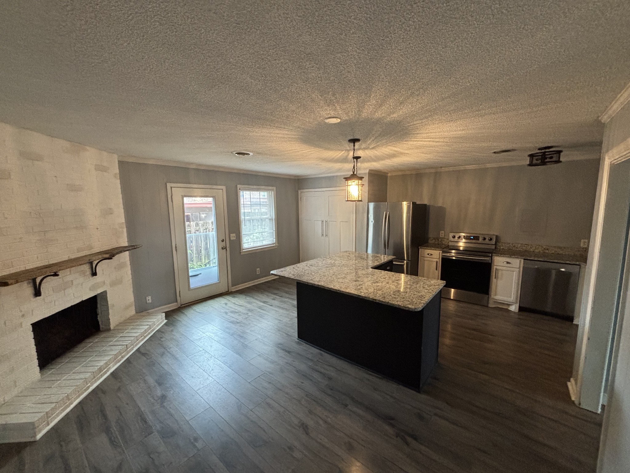 4001 Anderson Road, Unit C115 Nashville, TN 37217 - Photo 4 of 19 a living room with stainless steel appliances kitchen island hardwood floor and fireplace