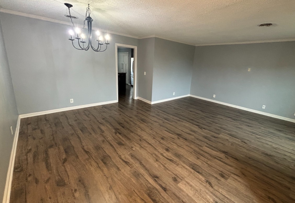 4001 Anderson Road, Unit C115 Nashville, TN 37217 - Photo 5 of 19 a view of an empty room with wooden floor and chandelier