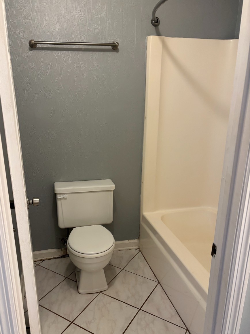 4001 Anderson Road, Unit C115 Nashville, TN 37217 - Photo 9 of 19 a white toilet sitting next to a bath tub