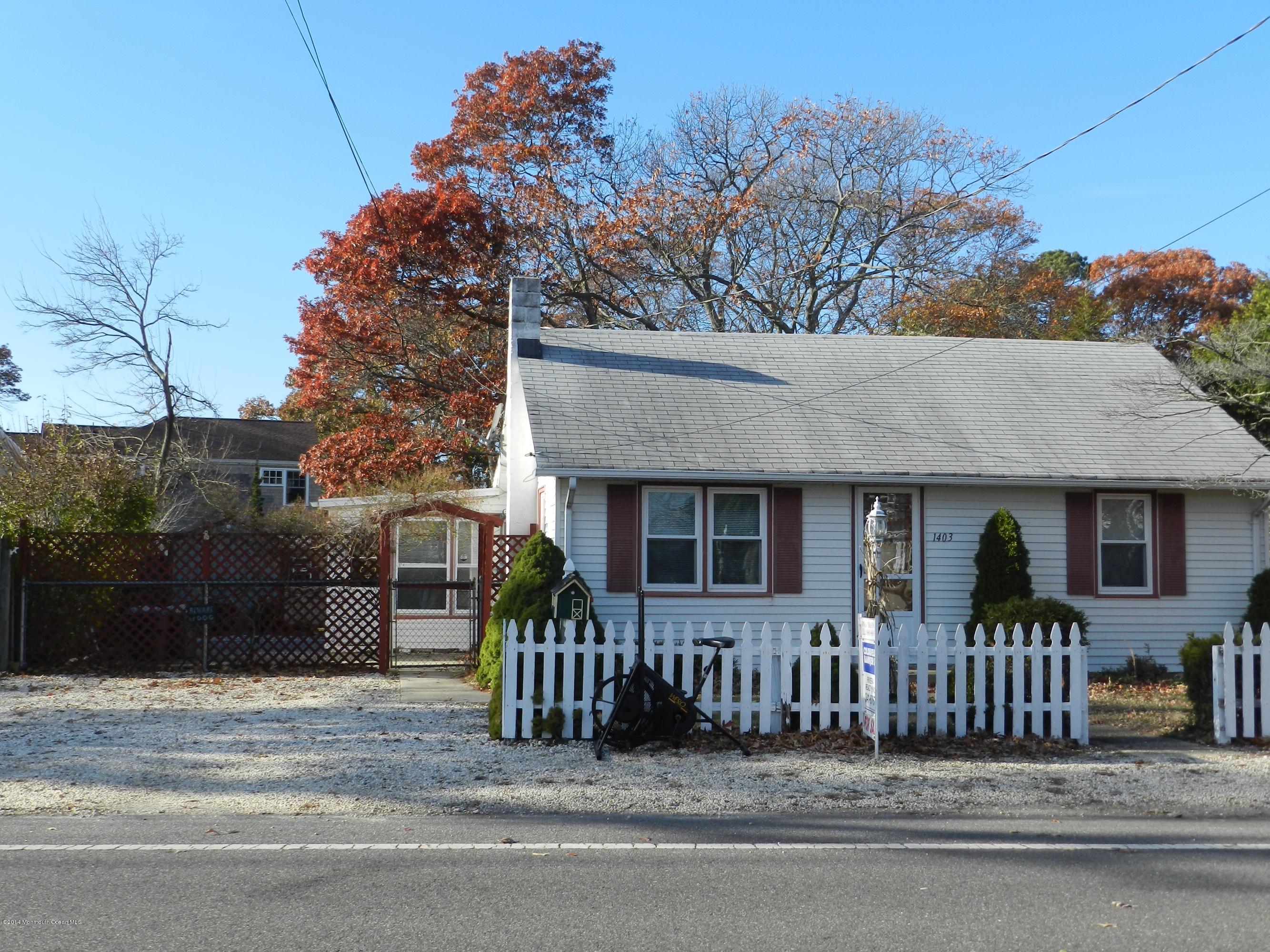 1403 Dorsett Dock Road Point Pleasant, NJ 08742 - Photo 1 of 18 a front view of a house with a yard