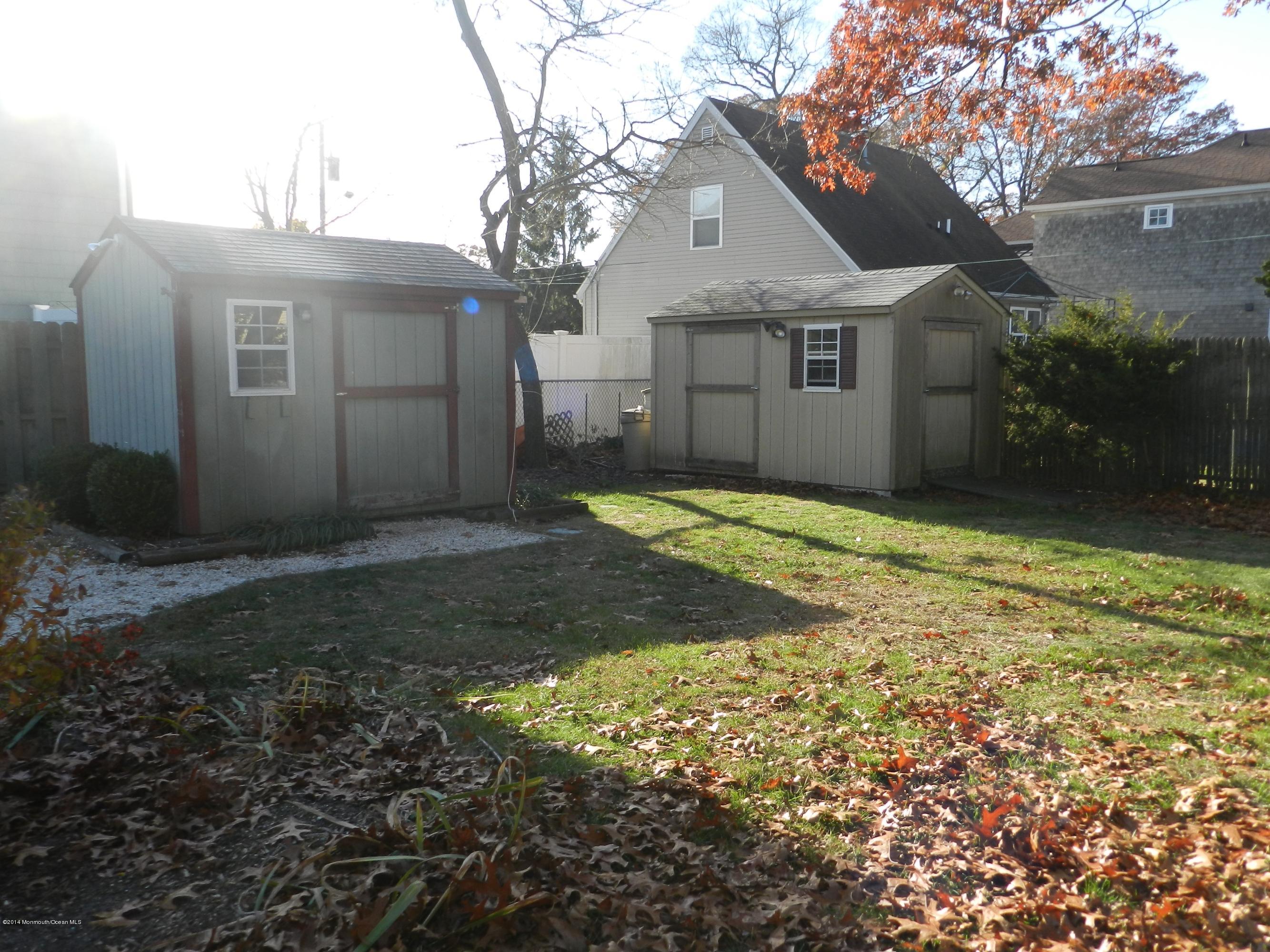 1403 Dorsett Dock Road Point Pleasant, NJ 08742 - Photo 17 of 18 a front view of a house with a yard and garage