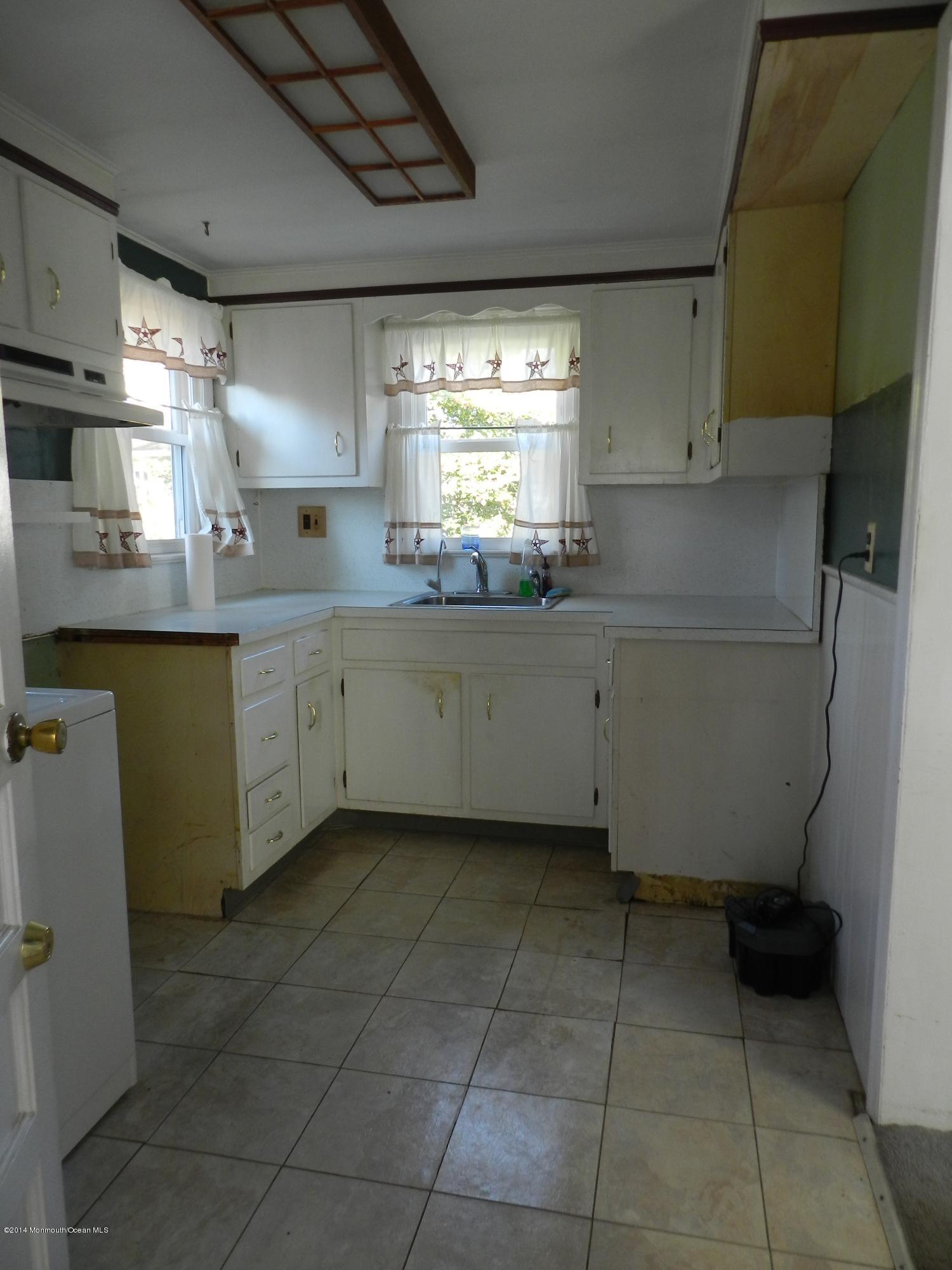1403 Dorsett Dock Road Point Pleasant, NJ 08742 - Photo 10 of 18 a kitchen with granite countertop a sink a stove a refrigerator and island