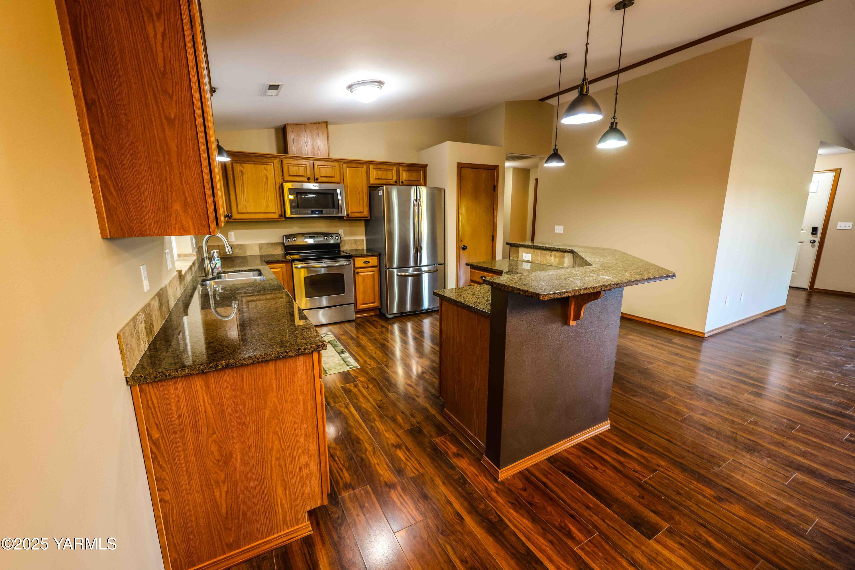 320 Westridge Road Selah, WA 98942 - Photo 21 of 53 a kitchen with stainless steel appliances granite countertop a sink a stove top oven a counter space and cabinets