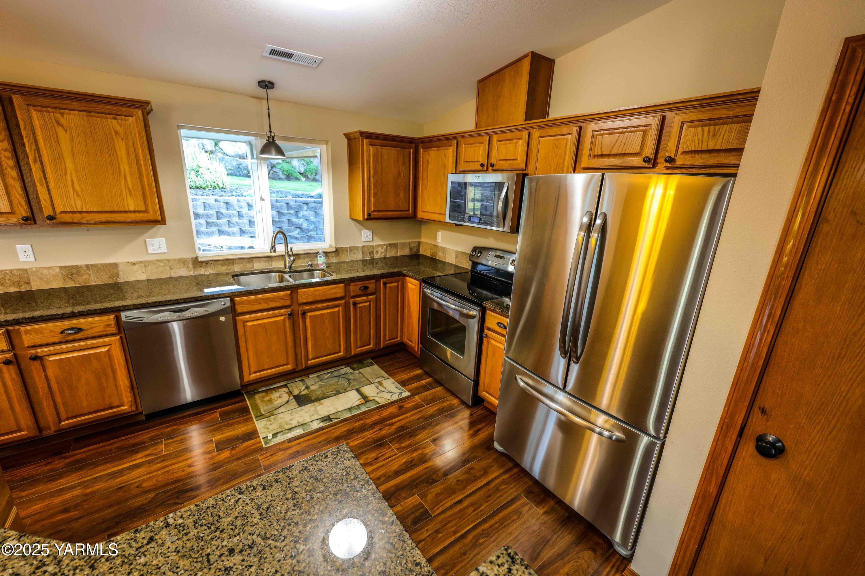 320 Westridge Road Selah, WA 98942 - Photo 23 of 53 a kitchen with wooden cabinets and sink