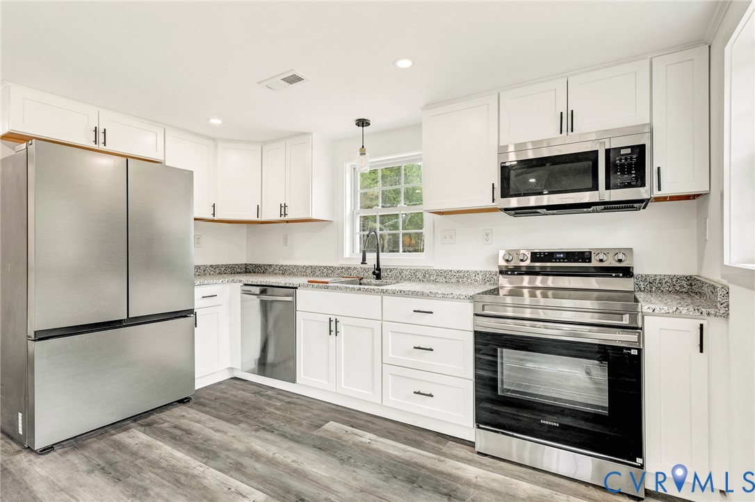 21139 Pendleton Road Bowling Green, VA 22427 - Photo 21 of 41 Modern kitchen featuring wood-finish flooring, whi