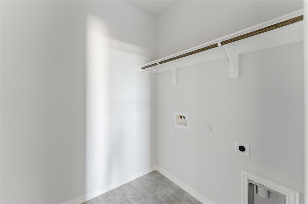 1221 Sabine River Lane Springtown, TX 76082 - Photo 11 of 25 Laundry area featuring hookup for a gas dryer, hookup for a washing machine, electric dryer hookup, and light tile patterned flooring