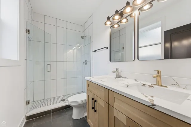 a bathroom with a toilet a sink and mirror