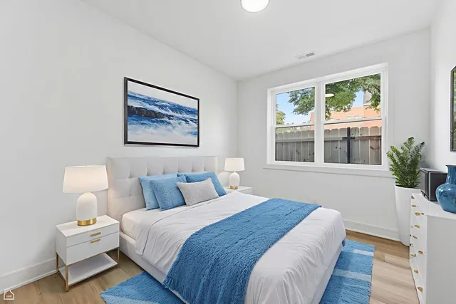 a bedroom with bed and wooden floor