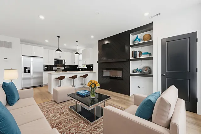 a living room with furniture and a kitchen view