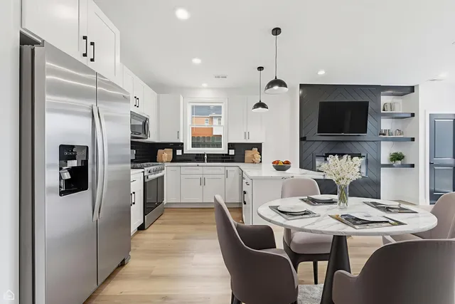 a kitchen with white cabinets and stainless steel appliances
