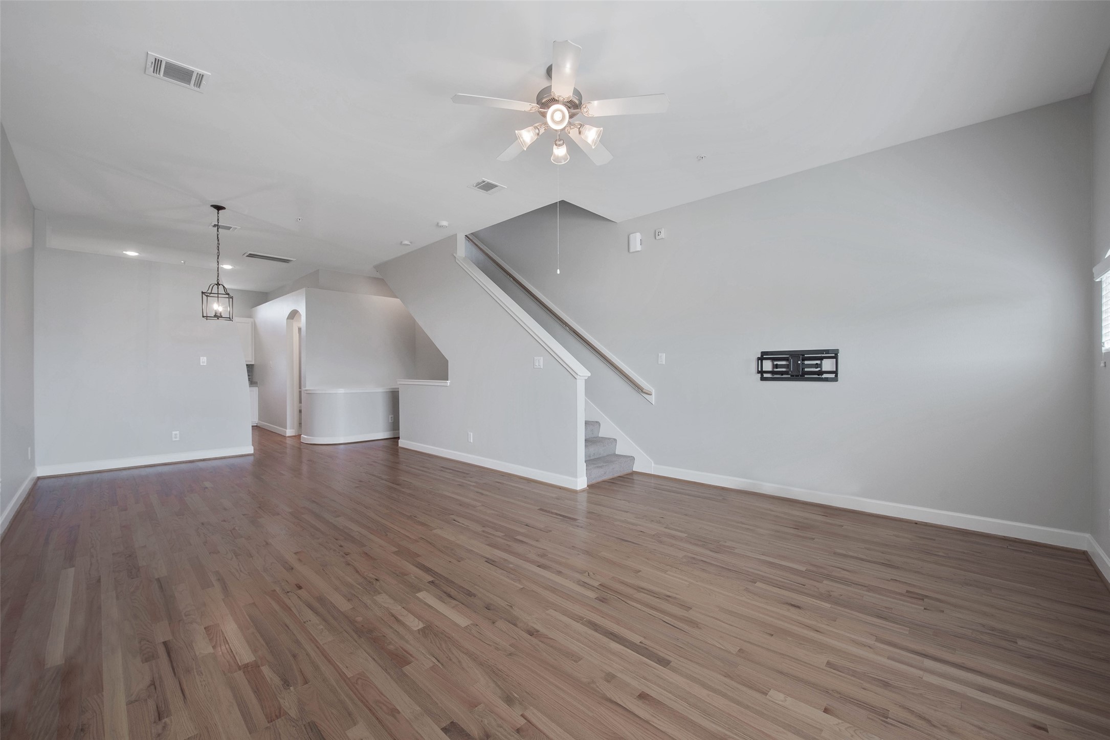 7650 Springhill Street, Unit 603 Houston, TX 77021 - Photo 6 of 26 a view of an empty room with wooden floor and a ceiling fan