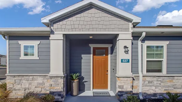 an aerial view of a house with a yard