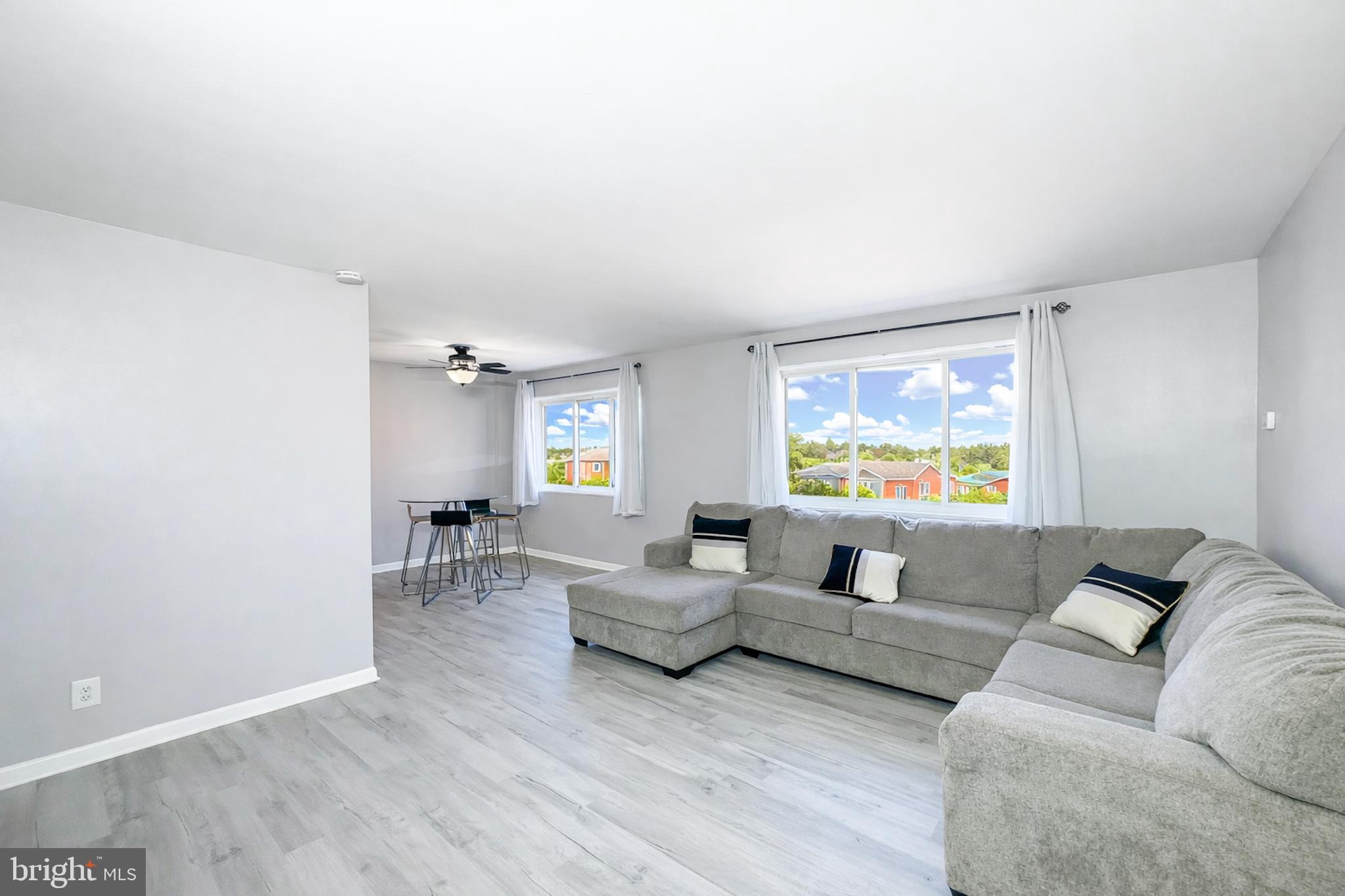 614 Sligo Avenue, Unit 405 Silver Spring, MD 20910 - Photo 11 of 29 a living room with furniture and a flat screen tv