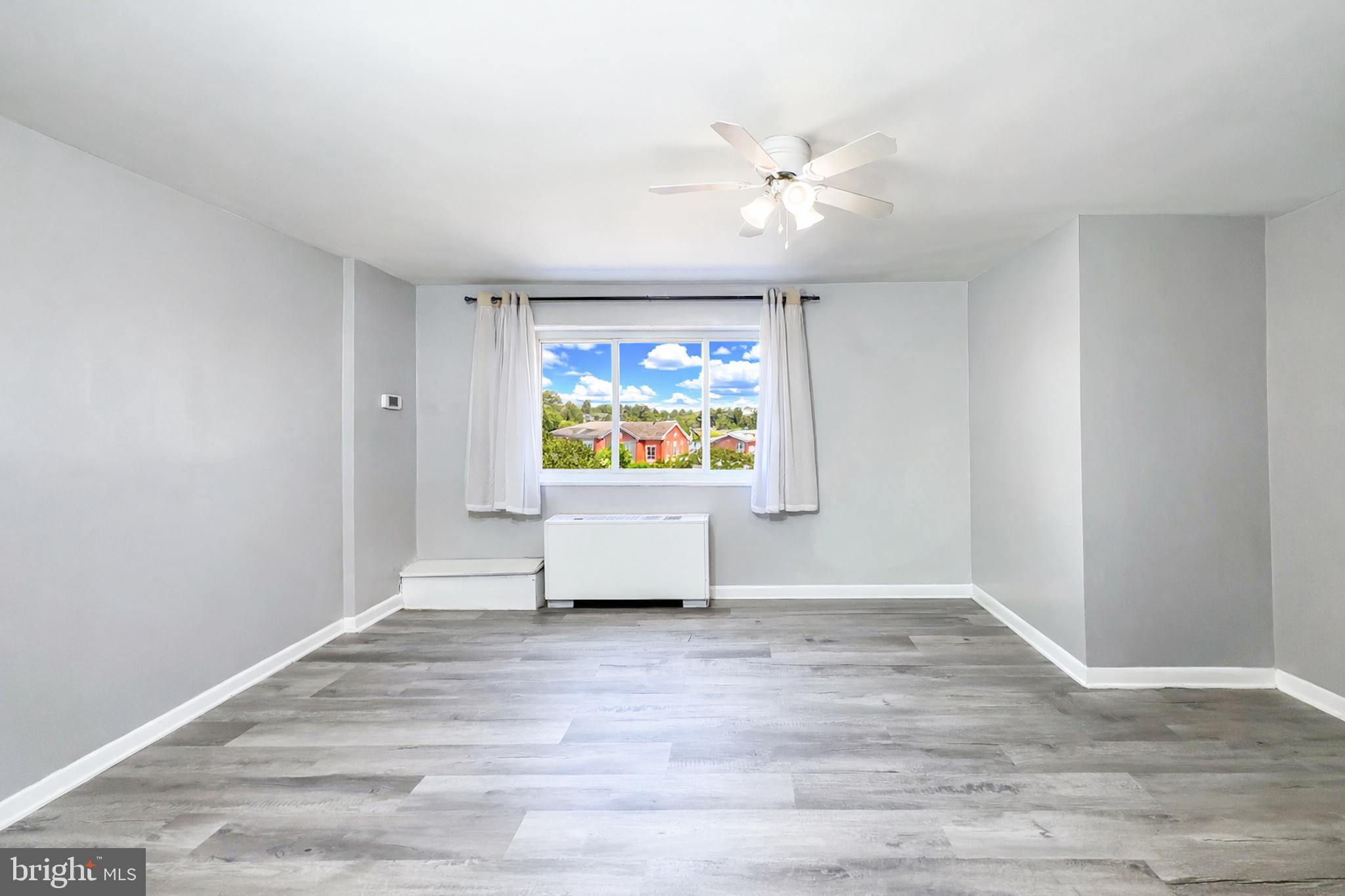 614 Sligo Avenue, Unit 405 Silver Spring, MD 20910 - Photo 12 of 29 a view of an empty room with window and wooden floor