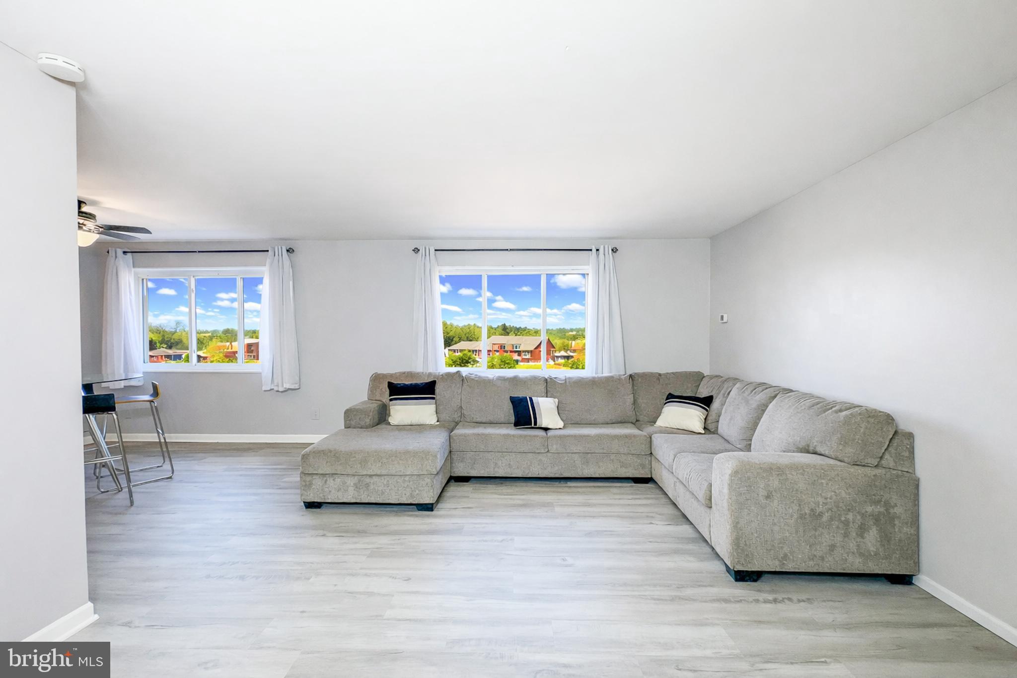 614 Sligo Avenue, Unit 405 Silver Spring, MD 20910 - Photo 13 of 29 a living room with furniture and a large window