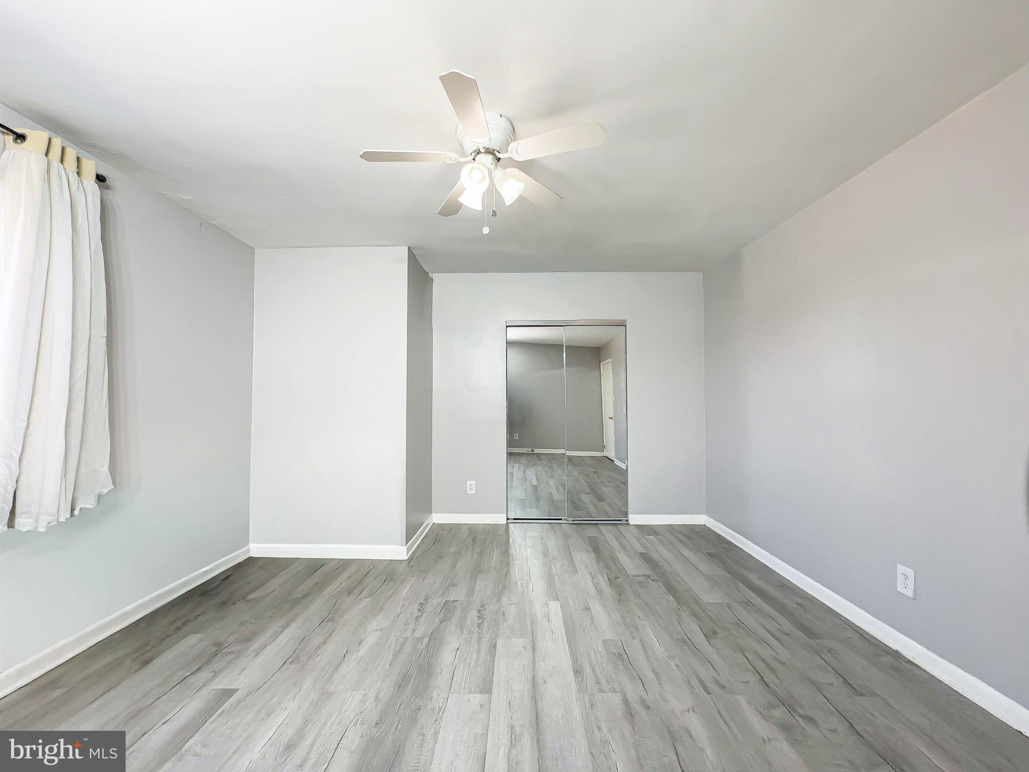 614 Sligo Avenue, Unit 405 Silver Spring, MD 20910 - Photo 21 of 29 wooden floor in an empty room with a window