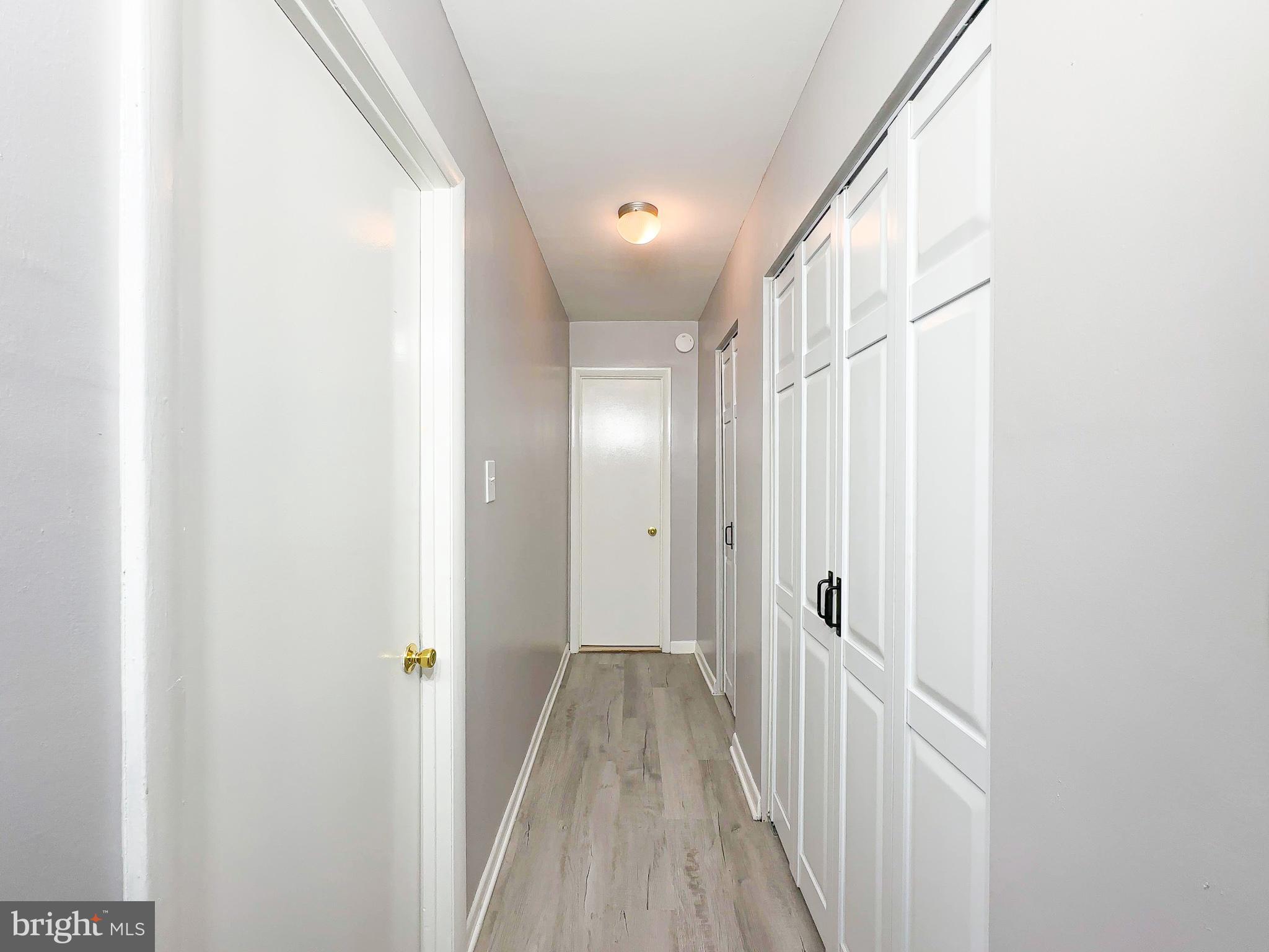 614 Sligo Avenue, Unit 405 Silver Spring, MD 20910 - Photo 24 of 29 a view of a hallway with wooden floor and staircase