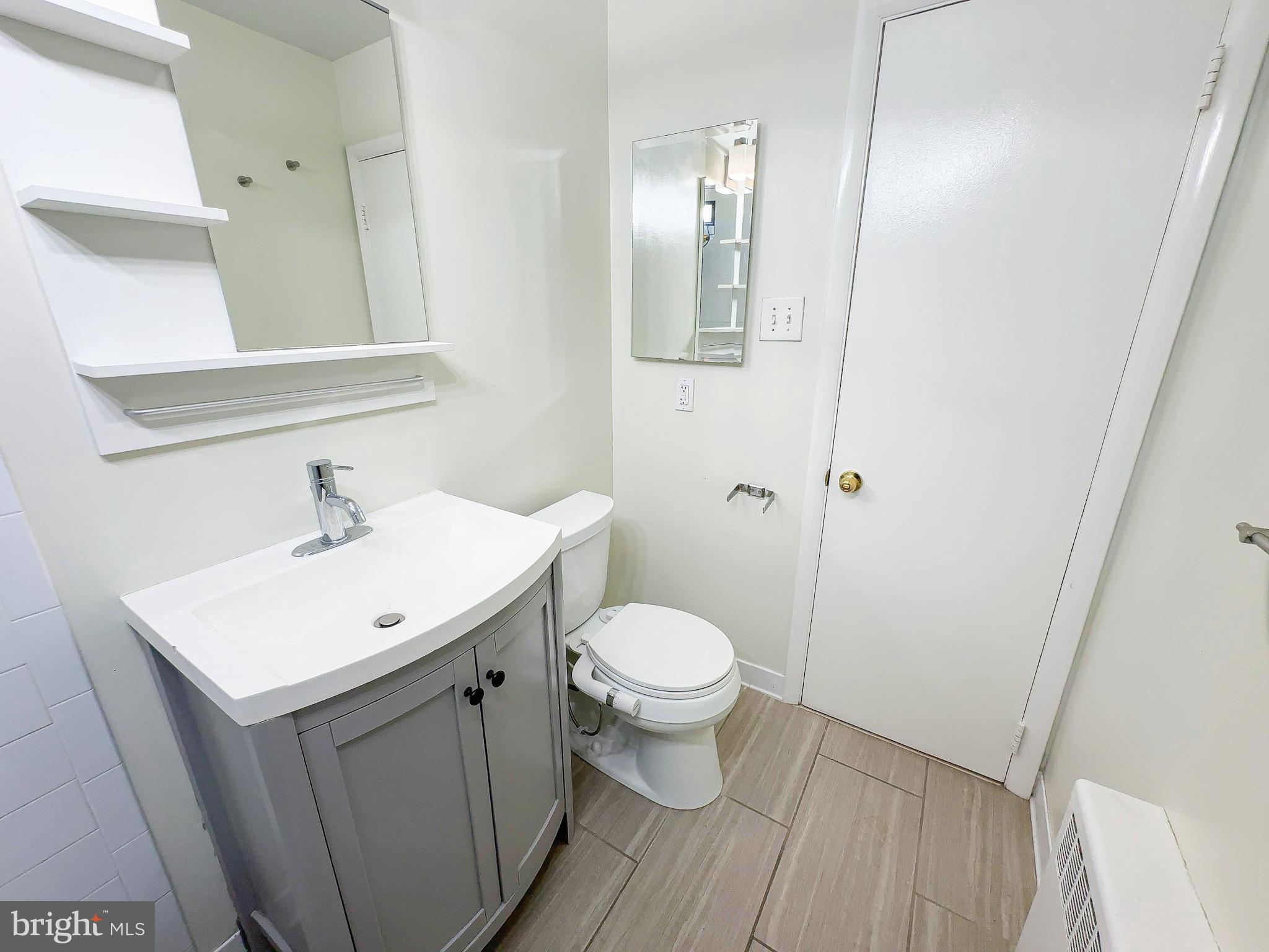 614 Sligo Avenue, Unit 405 Silver Spring, MD 20910 - Photo 29 of 29 a bathroom with a sink toilet and a mirror