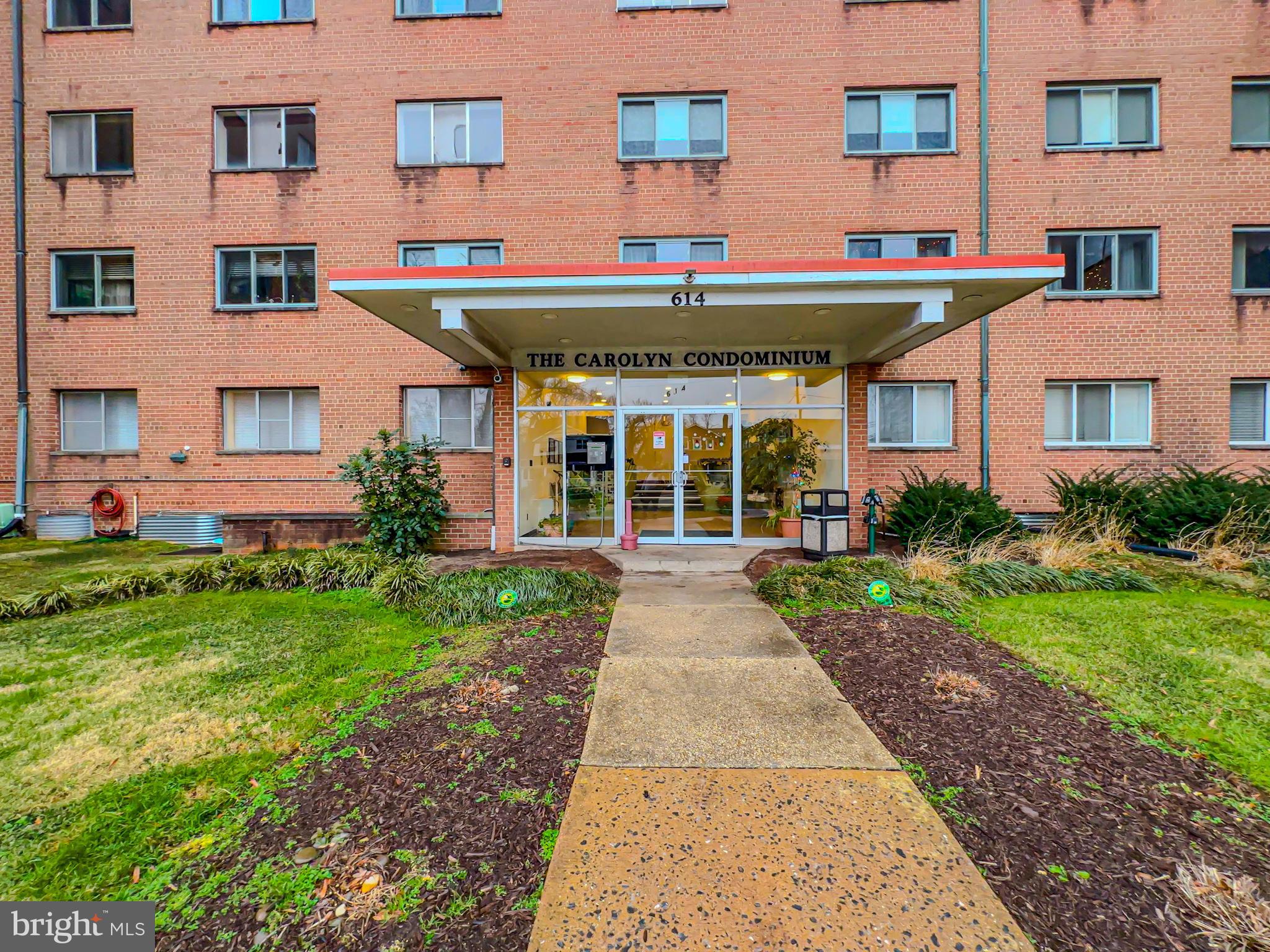 614 Sligo Avenue, Unit 405 Silver Spring, MD 20910 - Photo 10 of 29 a view of brick building with many windows and a yard