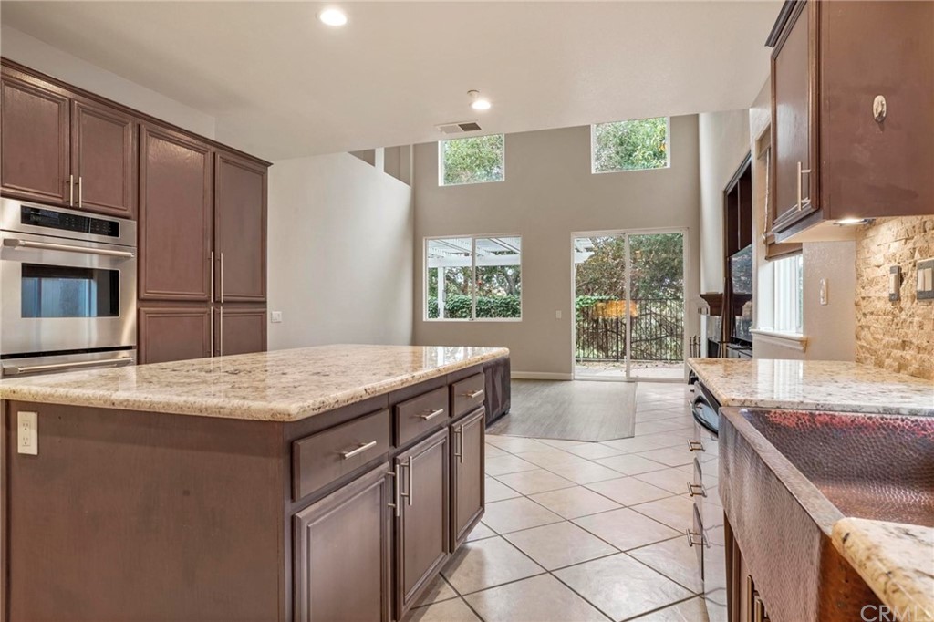 569 Inverlochy Drive Fallbrook, CA 92028 - Photo 11 of 36 a kitchen with stainless steel appliances granite countertop a sink and a stove