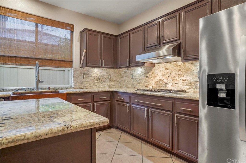 569 Inverlochy Drive Fallbrook, CA 92028 - Photo 12 of 36 a kitchen with stainless steel appliances granite countertop a refrigerator sink and cabinets