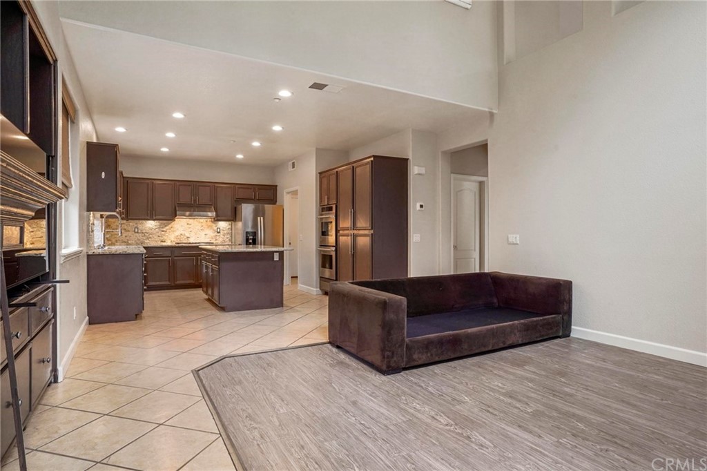 569 Inverlochy Drive Fallbrook, CA 92028 - Photo 14 of 36 a living room with stainless steel appliances kitchen island granite countertop furniture and a view of kitchen